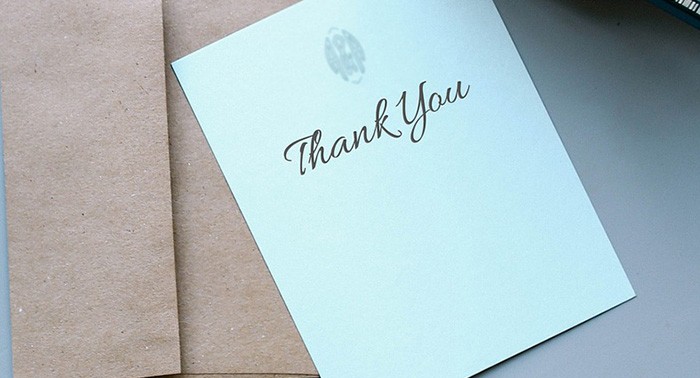Photo of a Thank You note sitting on a table