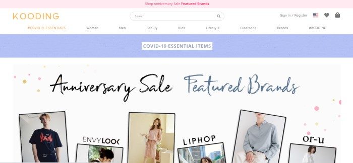 This screenshot of the home page for Kooding has a pink header, a white navigation bar with black text, a blue announcement bar, and a white main section showing several photos of Asian models wearing fashions for sale, along with black and blue text announcing an anniversary sale.