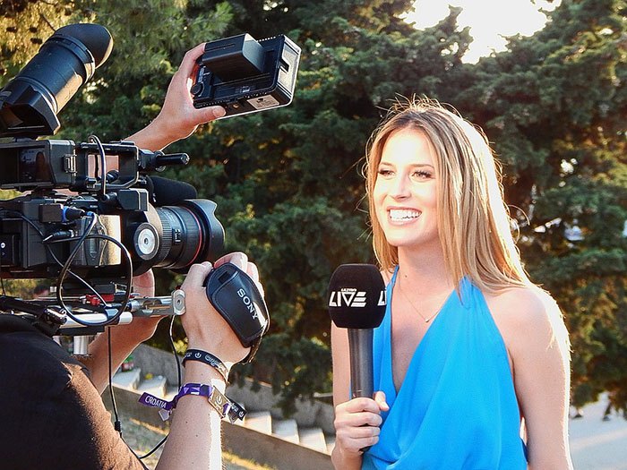 News reporter talking into a camera representing a person working in journalism
