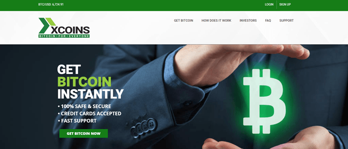 xCoins website screenshot showing a business man who appears to be holding a neon Bitcoin symbol between his hands.