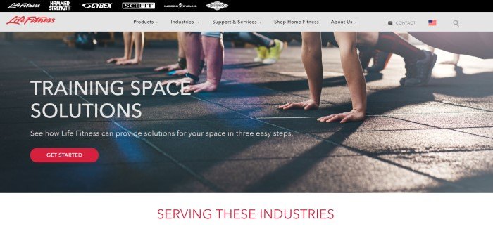 This screenshot of the home page for Life Fitness shows the hands and feet of a row of four people ready to do pushups on a dark tiled floor, near white text that reads 