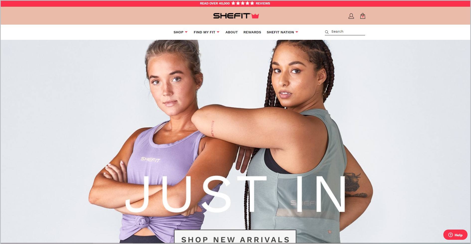 screenshot of SHEFIT homepage with red announcement bar, peach header with the website's name, underneath is the main navigation bar, it also showcases a couple of women sporting their workout outfit