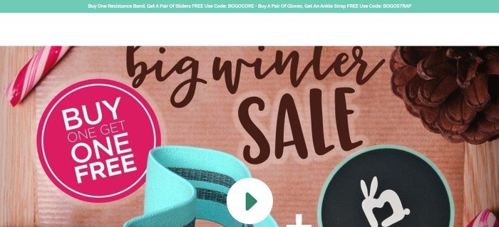 This screenshot of the home page for Mighty Buns has a pale green header announcing a sale, above a photo of a candy cane and an aqua-colored fitness accessory on a piece of brown cardboard that has black lettering on it reading 