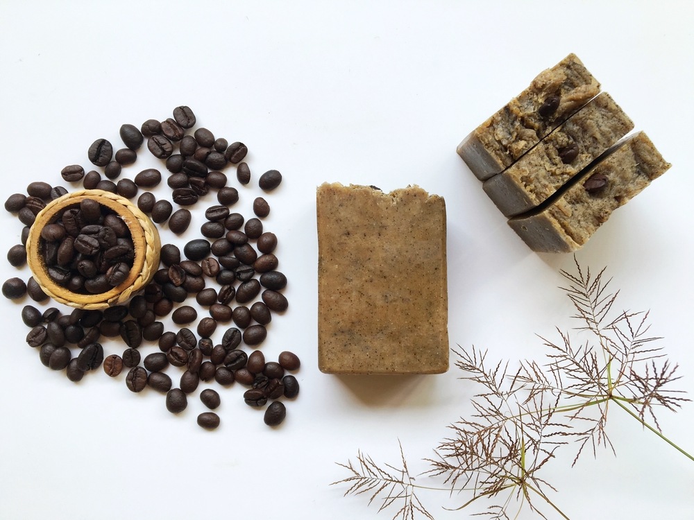 coffee scrub homemade soap with roasted coffee beans on white background
