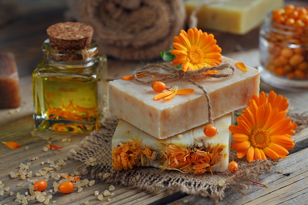 handmade soap with essential oil corked bottle and orange flowers