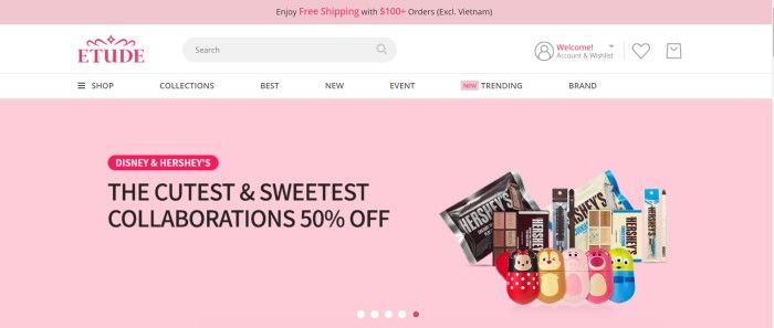 This screenshot of the home page for Etude has a pink header and main section wtih black and pink text, along with a photo of skincare products created to look like Hershey's chocolate bars and Disney toys, as well as a white navigation bar with black and pink text.