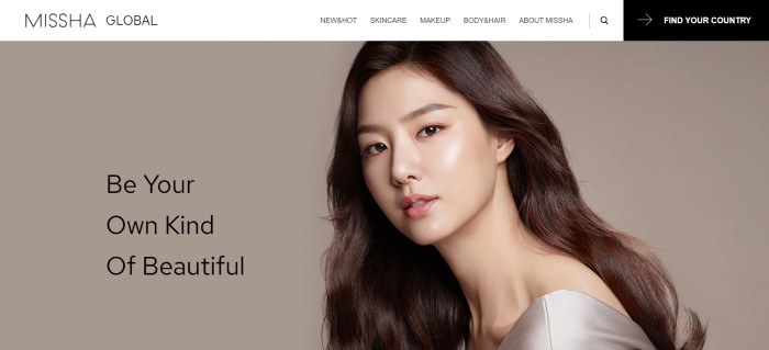 This screenshot of Missha has a white navigation bar above a large section with a light brown background, black text on the left side of the page, and a photo of a beautiful Asian woman on the right side of the page.