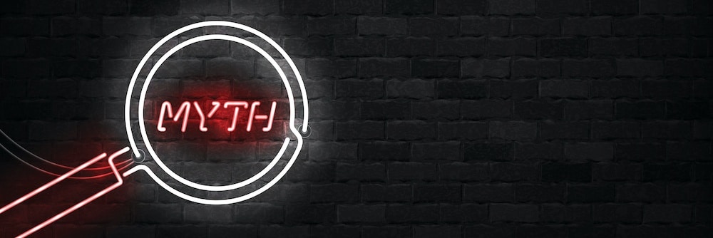 black brick wall with neon text 