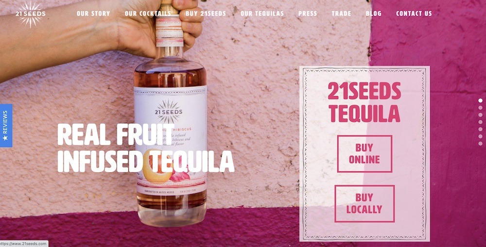 The 21 Seeds Tequila website shows a woman's hand gripping a bottle next to a pink building.