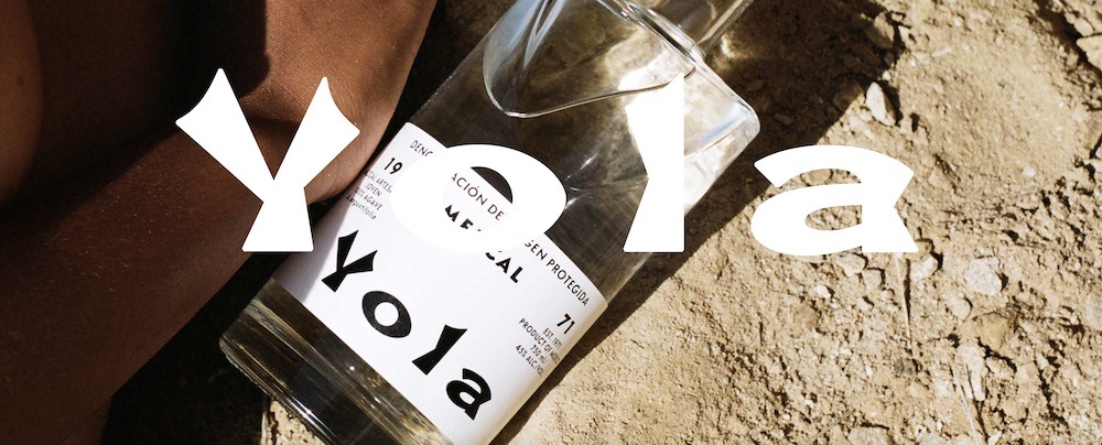Yola Mezcal's features a bottle with a field in the background.