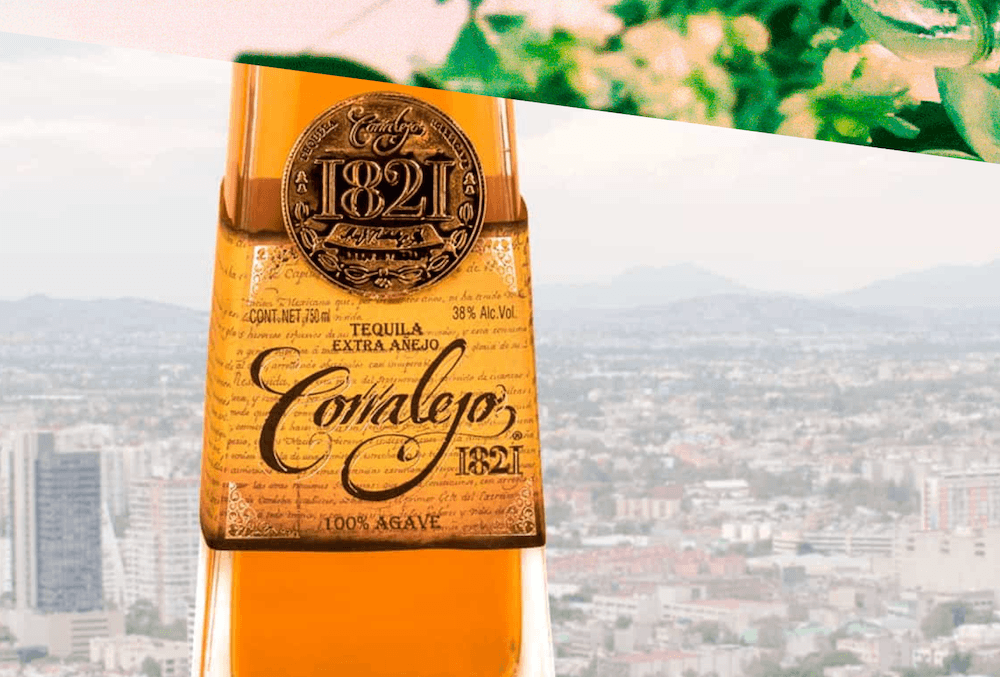 A bottle of Tequila Corizon 1821 superimposed over a background of Mexico City.