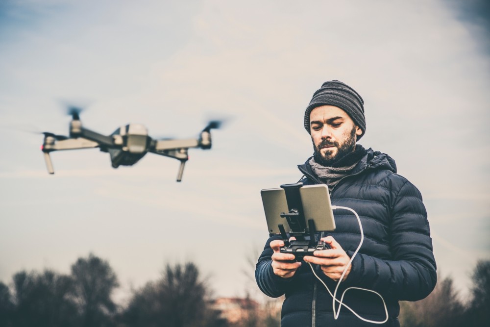 man with ipad running professional drone business